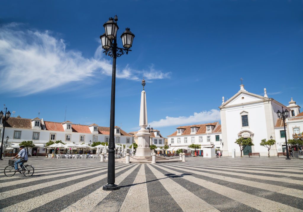 VILA REAL DE SANTO ANTONIO, PORTUGAL - SEP 23 2015.  The attractive paving of the town's main plaza, in Vila Real de Santo Antonio. The most South Eastern town of Portugal. A local man can be seen cycling across the square.